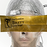 Vorschaubild: Das Goldene Brett 2023 - Gesicht mit goldenem Brett vor dem Kopf, Sujet mit Störer